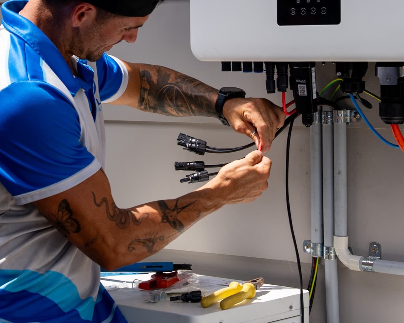 Coastline electrician wiring up an inverter and isolator